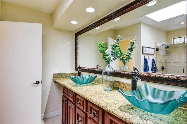 166 N Singingwood St Unit 9, Orange, CA 92869 - bathroom featuring double vanity, recessed lighting, a sink, a stall shower, and a skylight