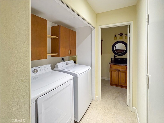 166 N Singingwood St Unit 9, Orange, CA 92869 - laundry area featuring washing machine and dryer, cabinet space, and light tile patterned flooring