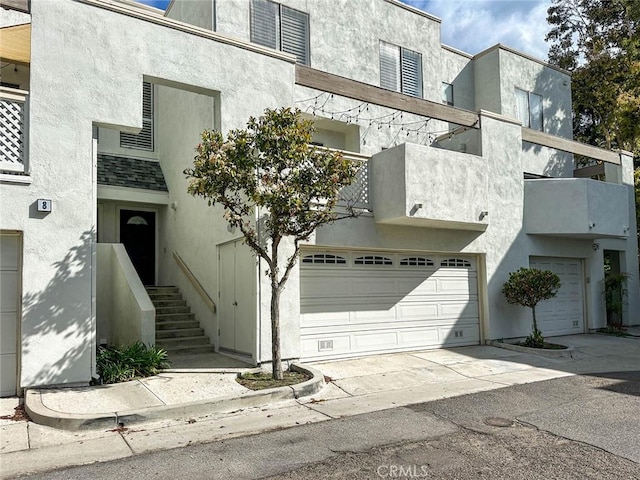 166 N Singingwood St Unit 9, Orange, CA 92869 - view of property with an attached garage and concrete driveway