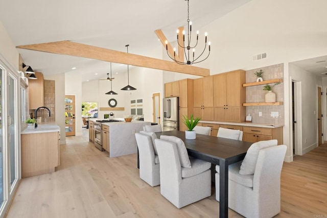 dining room with visible vents, high vaulted ceiling, light wood finished floors, an inviting chandelier, and recessed lighting