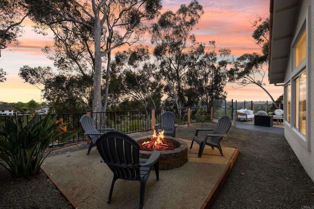 view of patio with fence and a fire pit