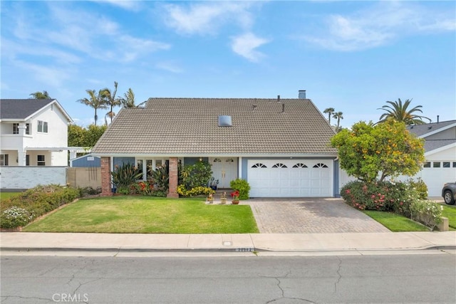 20902 Balgair Cir, Huntington Beach, CA 92646 - view of front of house with fence, a front lawn, a garage, a tiled roof, and driveway