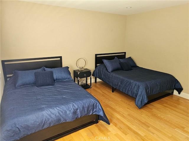 bedroom with baseboards and wood finished floors