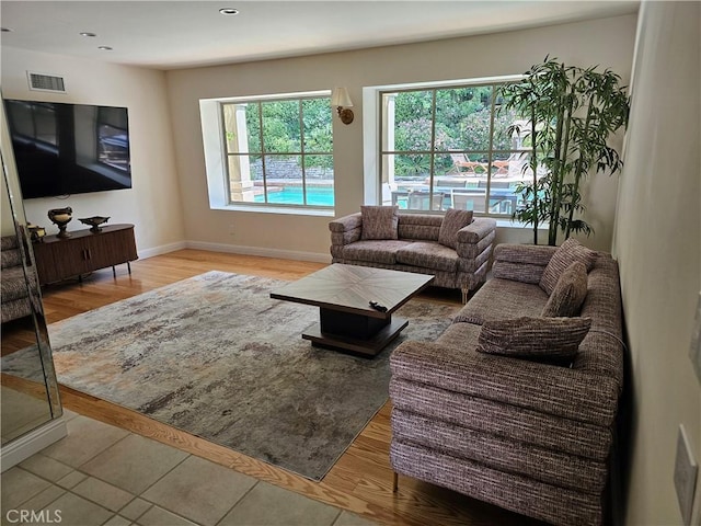 living area featuring baseboards, recessed lighting, wood finished floors, and visible vents