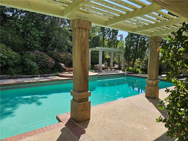 outdoor pool with a pergola and a patio area