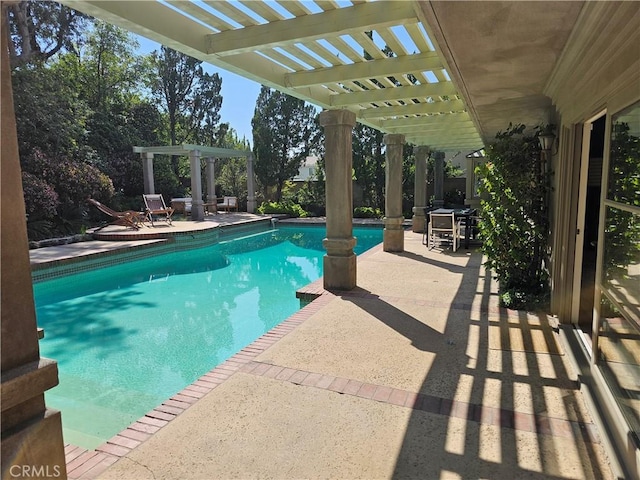 pool with a patio area and a pergola