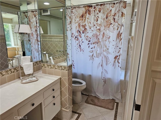 full bathroom featuring tile walls, curtained shower, tile patterned floors, vanity, and toilet