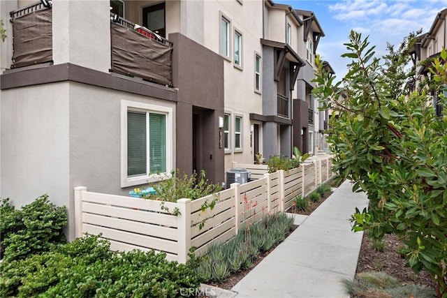 exterior space featuring fence and central AC unit