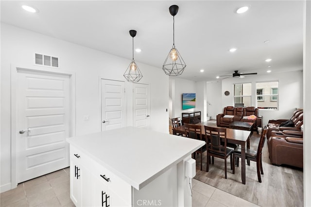 kitchen with a ceiling fan, open floor plan, white cabinetry, recessed lighting, and visible vents
