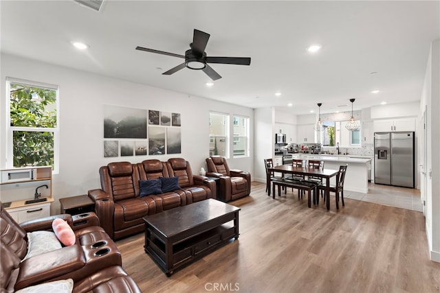 living room with recessed lighting, ceiling fan, visible vents, and light wood-style flooring