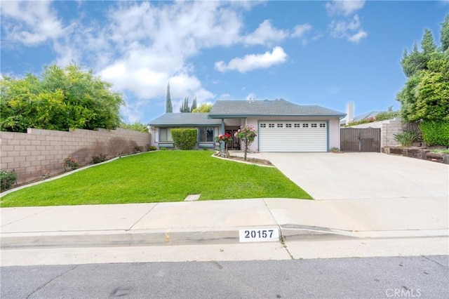 ranch-style home with a garage, a front lawn, fence, and driveway