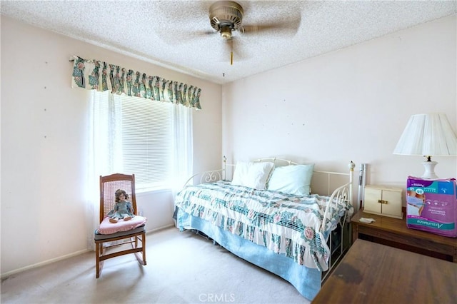 carpeted bedroom featuring a ceiling fan, a textured ceiling, and baseboards