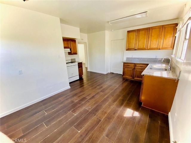 2853 Buckingham Rd, Los Angeles, CA 90016 - kitchen featuring dark wood finished floors, brown cabinetry, a sink, and white gas range