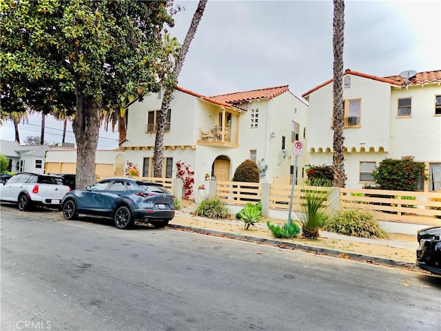 2853 Buckingham Rd, Los Angeles, CA 90016 - mediterranean / spanish-style house featuring fence, stucco siding, and a tiled roof