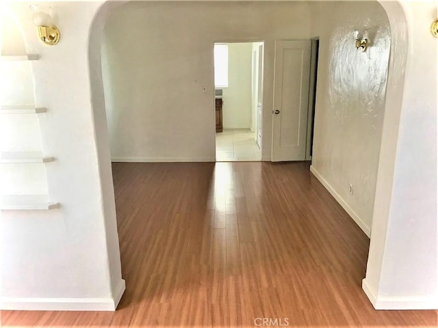 2853 Buckingham Rd, Los Angeles, CA 90016 - interior space with arched walkways, baseboards, and wood finished floors