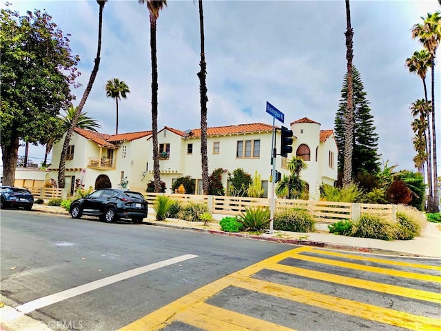 2853 Buckingham Rd, Los Angeles, CA 90016 - view of front of home featuring fence, stucco siding, and a tile roof