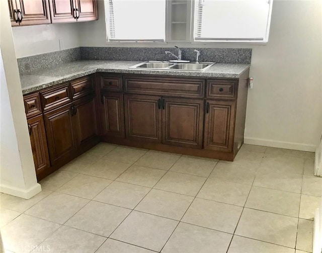 2853 Buckingham Rd, Los Angeles, CA 90016 - kitchen with baseboards, a sink, and light tile patterned floors