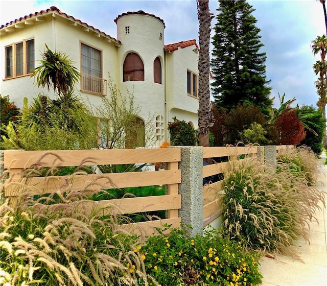 2853 Buckingham Rd, Los Angeles, CA 90016 - mediterranean / spanish-style house featuring stucco siding, fence, and a tile roof
