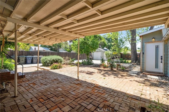 view of patio with a fenced backyard, a shed, and an outbuilding