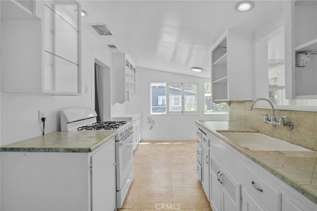 kitchen with white cabinets, visible vents, white range with gas stovetop, and a sink