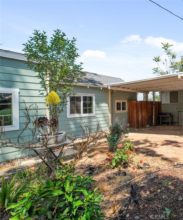 exterior space featuring fence and an attached carport