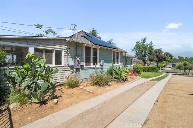 bungalow-style home with solar panels