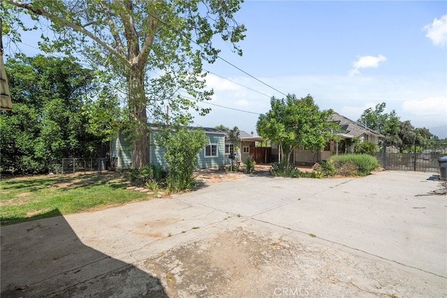 view of front of home featuring fence and concrete driveway