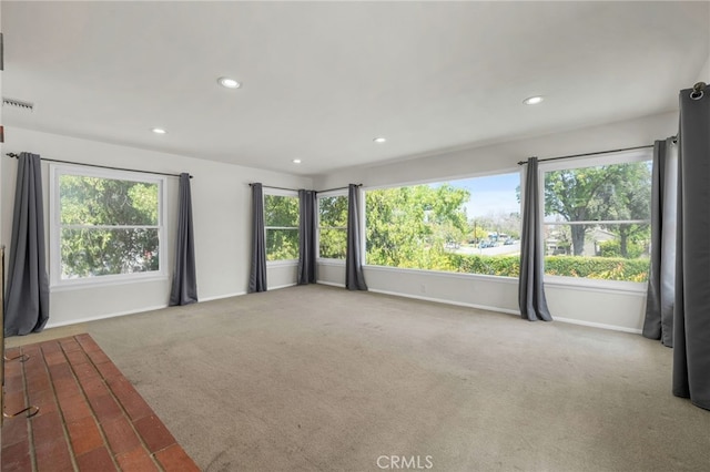 carpeted spare room with baseboards, recessed lighting, and visible vents