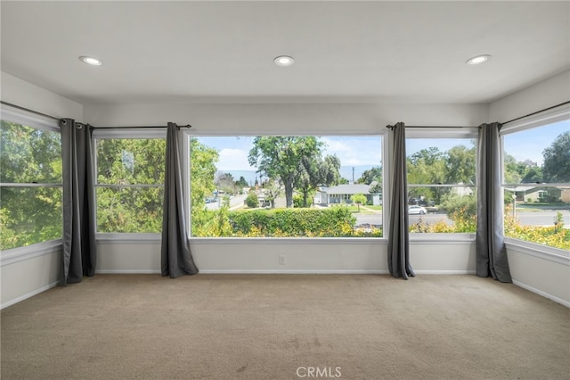 carpeted empty room with baseboards and recessed lighting