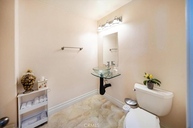 2830 Mount Niguel Cir, Corona, CA 92882 - bathroom featuring toilet, baseboards, a sink, and marble finish floor