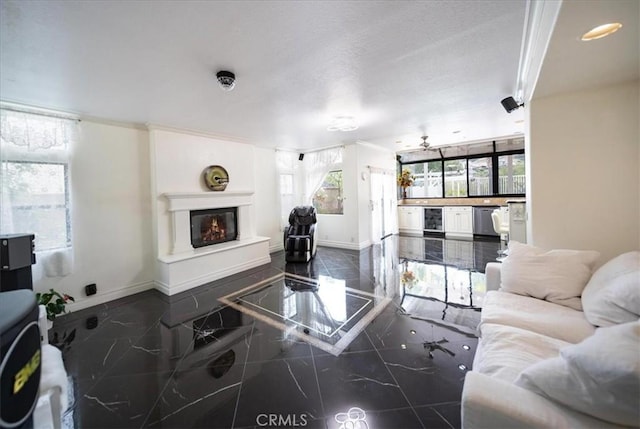 2830 Mount Niguel Cir, Corona, CA 92882 - living area featuring baseboards, a glass covered fireplace, granite finish floor, and beverage cooler