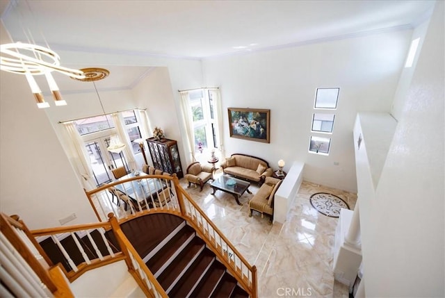 2830 Mount Niguel Cir, Corona, CA 92882 - living area featuring a notable chandelier, ornamental molding, marble finish floor, and a towering ceiling