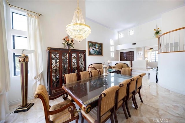 2830 Mount Niguel Cir, Corona, CA 92882 - dining space featuring ceiling fan with notable chandelier, marble finish floor, baseboards, a towering ceiling, and visible vents