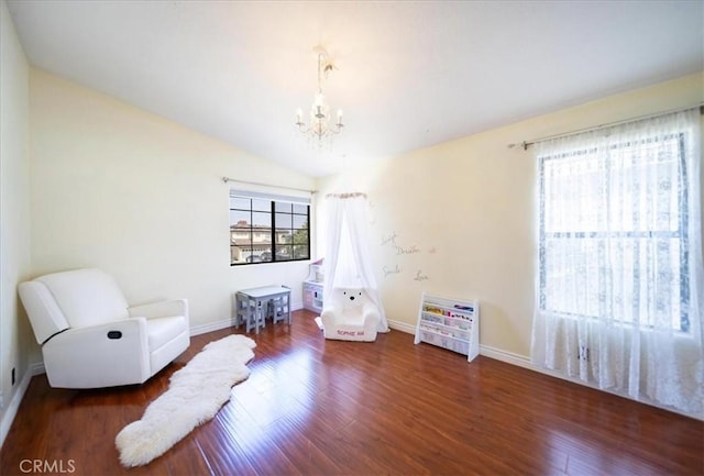 2830 Mount Niguel Cir, Corona, CA 92882 - living area featuring baseboards, wood finished floors, a notable chandelier, and vaulted ceiling