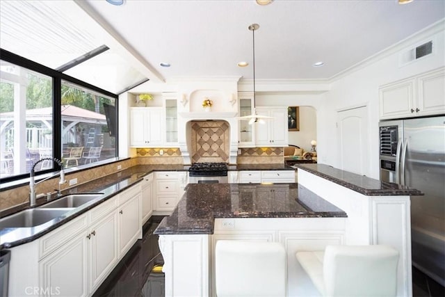 2830 Mount Niguel Cir, Corona, CA 92882 - kitchen featuring a kitchen island, visible vents, appliances with stainless steel finishes, a sink, and white cabinets