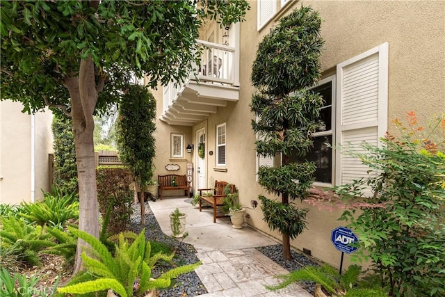 27014 Monterey Ave, Valencia, CA 91355 - view of exterior entry featuring a balcony and stucco siding