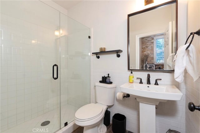bathroom featuring toilet, tile walls, and a shower stall