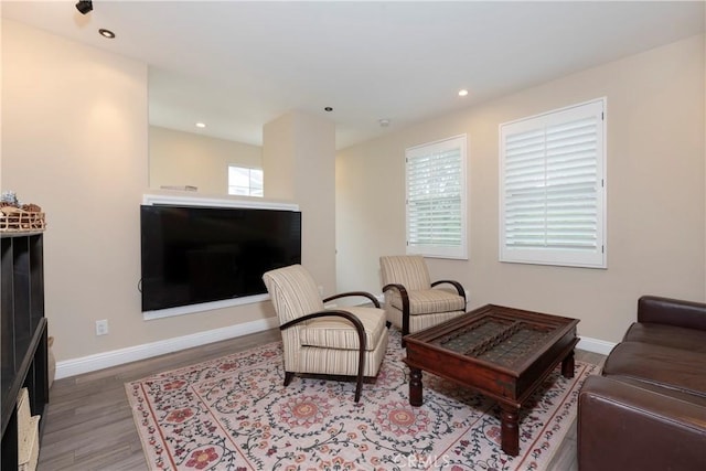 living room featuring recessed lighting, baseboards, and wood finished floors