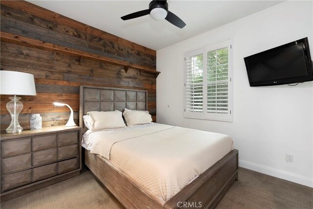 27014 Monterey Ave, Valencia, CA 91355 - bedroom with wooden walls, carpet flooring, baseboards, and ceiling fan