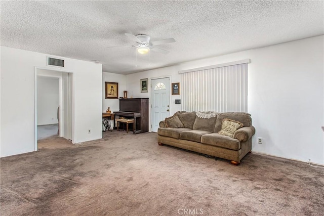carpeted living area featuring ceiling fan, a textured ceiling, and visible vents