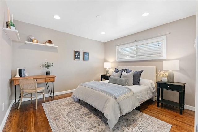 bedroom with baseboards, recessed lighting, and wood finished floors