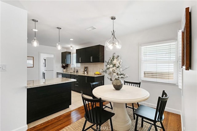 dining space with baseboards, recessed lighting, light wood-style flooring, and visible vents
