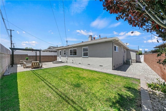 back of house with stucco siding, crawl space, a fenced backyard, a lawn, and a patio