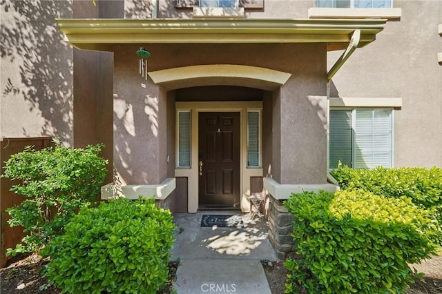 doorway to property with stucco siding