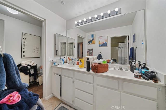 bathroom with double vanity, a sink, tile patterned floors, and curtained shower