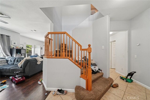 stairs featuring baseboards, tile patterned floors, and visible vents