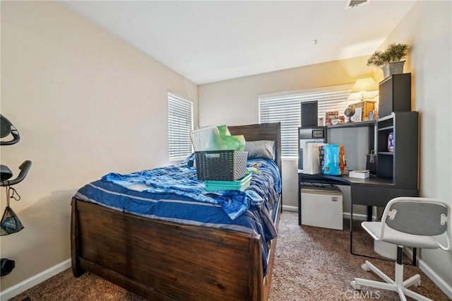 bedroom with baseboards and carpet