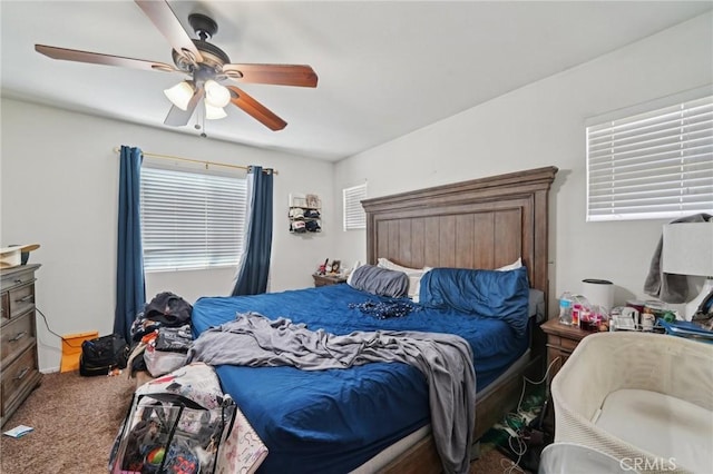 bedroom featuring a ceiling fan and carpet