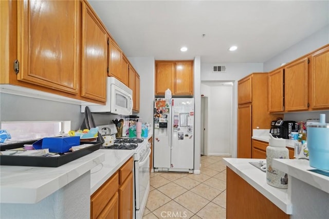 kitchen featuring visible vents, light countertops, light tile patterned floors, recessed lighting, and white appliances