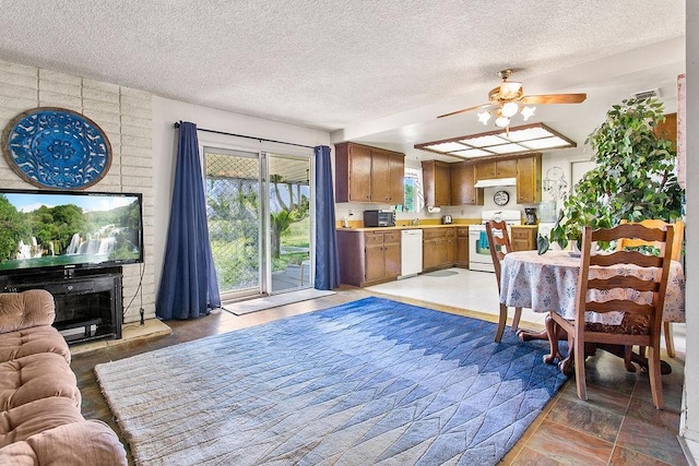 living area featuring a textured ceiling and ceiling fan